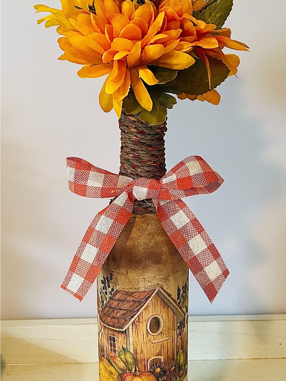 Rustic Pumpkin House Bottle Decor with Orange Floral Top and Gingham Bow